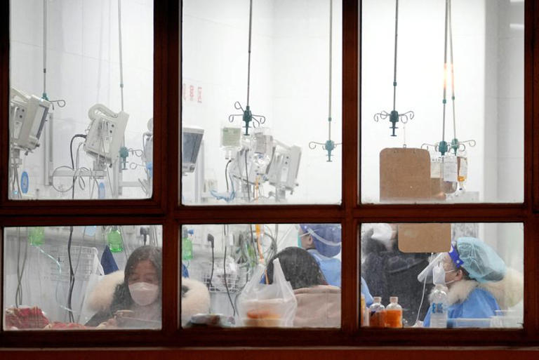 People are seen inside a health facility in Shanghai dealing with China's massive Covid outbreak