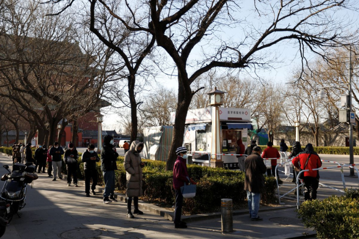 People line up at a nucleic acid testing site to get tested for Covid-19 in Beijing, China