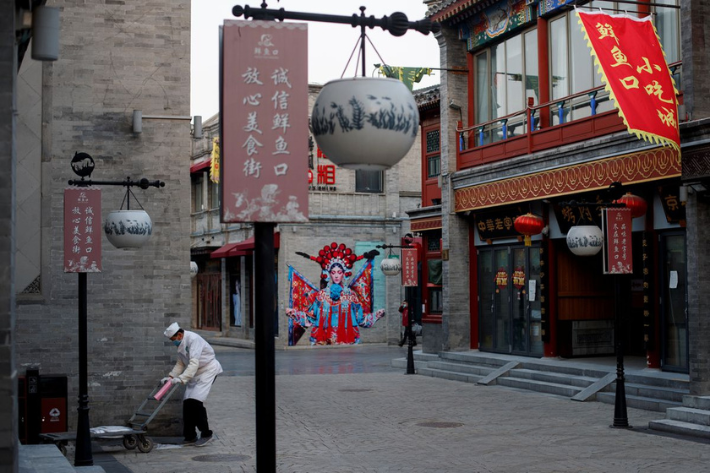 A kitchen worker pushes a trolley in the Qianmen district, one of the top tourist destinations in Beijing, as the spread of the novel coronavirus disease continues in China