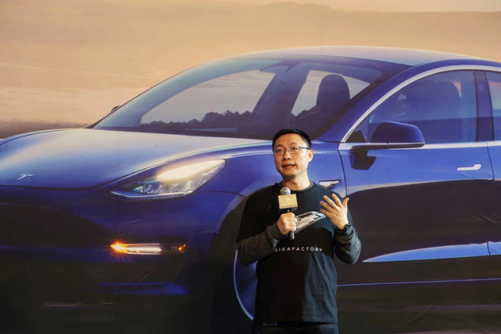 Tesla's China chief Tom Zhu speaks at a delivery ceremony for China-made Tesla Model 3 vehicles in the Shanghai Gigafactory of the US electric car maker in Shanghai