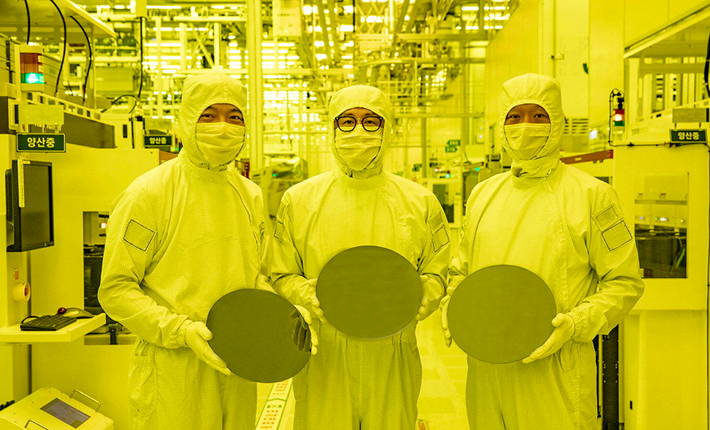 Staff at Samsung Electronics with wafers at its chip plant in Hwaseong, South Korea