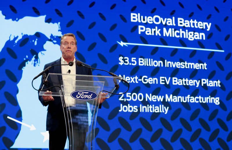 A Ford Motor executive is seen with a screen showing the company's Michigan battery plant plan (Rs)