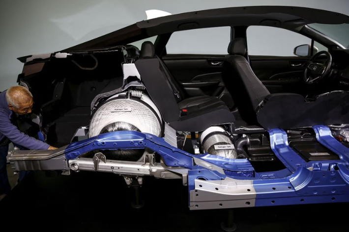 A man looks at the inside of a Honda Clarity, Honda Motor's first mass-market fuel-cell vehicle after its presentation at the company's headquarters in Tokyo, Japan, March 10, 2016