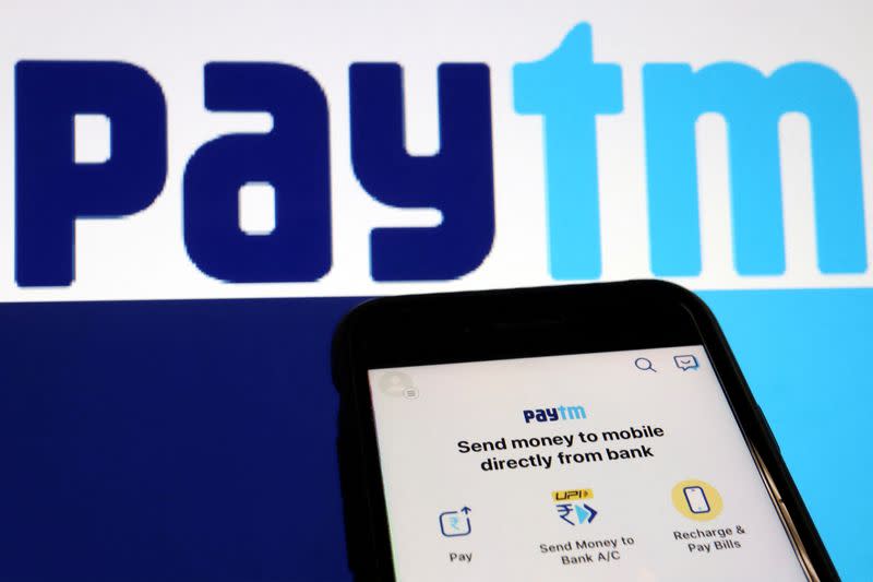 The interface of Indian payments app Paytm is seen in front of its logo