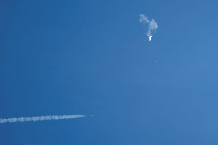 A jet flies by a suspected Chinese spy balloon after shooting it down off the coast in Surfside Beach, South Carolina, U.S. February 4