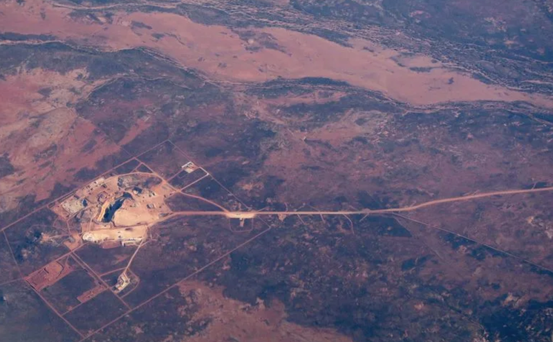 A road leads to an open-cut mine in the area known as the Pilbara region located in the north-west of Western Australia