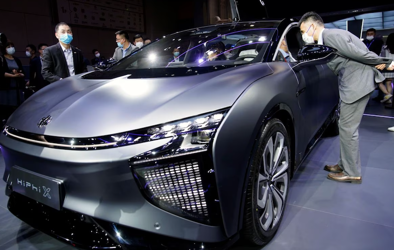 Visitors check a HiPhi X electric vehicle (EV) displayed during a media day for the Auto Shanghai show in Shanghai, China April 20, 2021. REUTERS/Aly Song