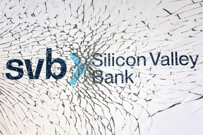 SVB (Silicon Valley Bank) logo is seen through broken glass in this illustration