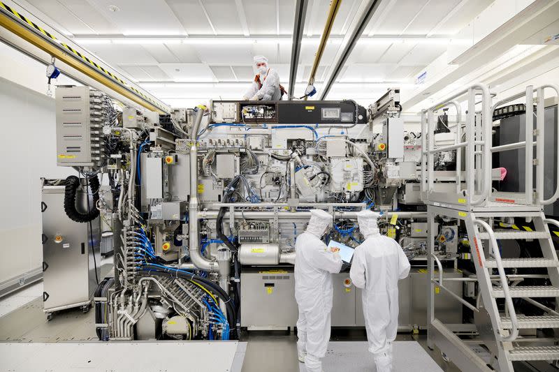 Employees work to assemble ASML's Twinscan NXE3400B chip lithography tool in Veldhoven