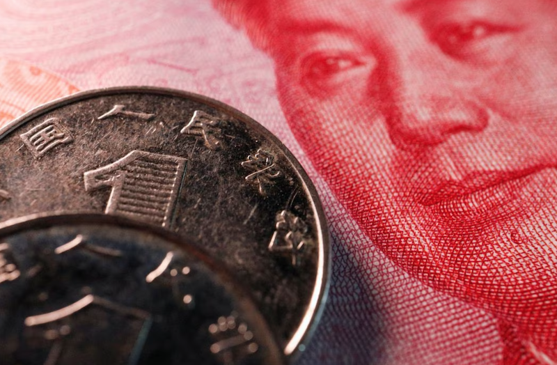 Coins and a banknote of China's yuan are seen in this illustration picture taken February 24, 2022. Photo: Reuters