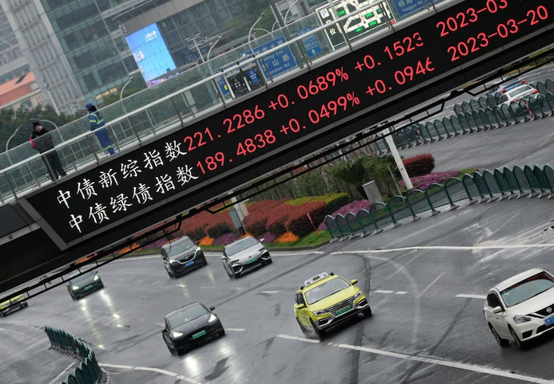 An electronic board shows stock indexes at the Lujiazui financial district in Shanghai, China, March 21, 2023. REUTERS/Aly Song