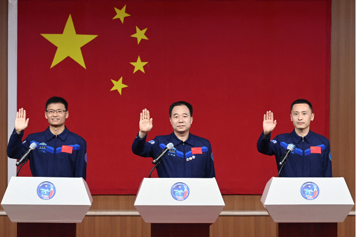 Astronauts Jing Haipeng, Zhu Yangzhu and Gui Haichao attend a press conference before the Shenzhou-16 spaceflight mission to China's space station, at Jiuquan Satellite Launch Center, near Jiuquan, Gansu province, China