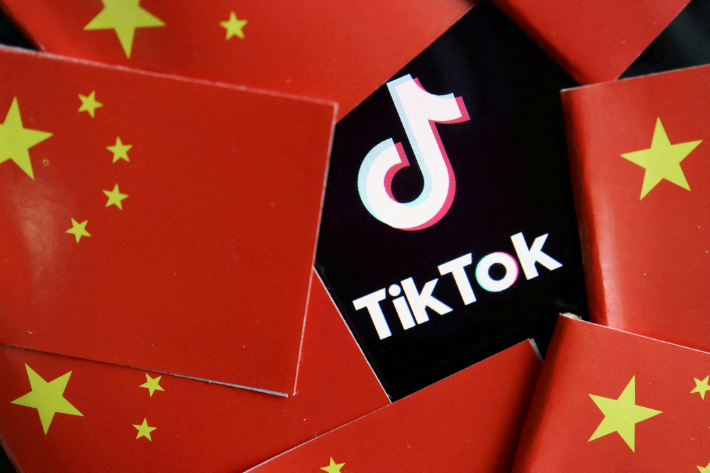 China's flags are seen near a TikTok logo