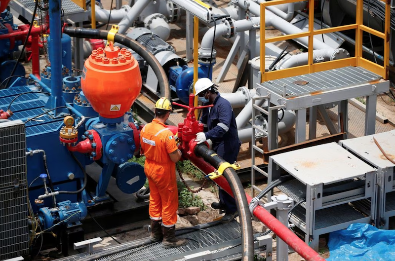 Technicians work at an oil rig at an Oil and Natural Gas Corp (ONGC) plant, in Dhamasna village in the western state of Gujarat, India, August 26, 2021. REUTERS/Amit Dave/File Photo