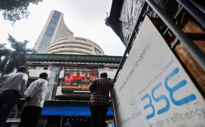 People stand outside the Bombay Stock Exchange (BSE), after Sensex surpassed the 60,000 level for the first time, in Mumbai, India, September 24, 2021. REUTERS/Francis Mascarenhas