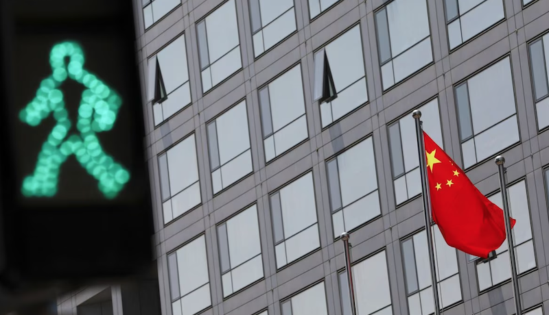 A Chinese national flag flutters outside the China Securities Regulatory Commission (CSRC) building on the Financial Street in Beijing, China July 9, 2021. REUTERS/Tingshu Wang/File Photo