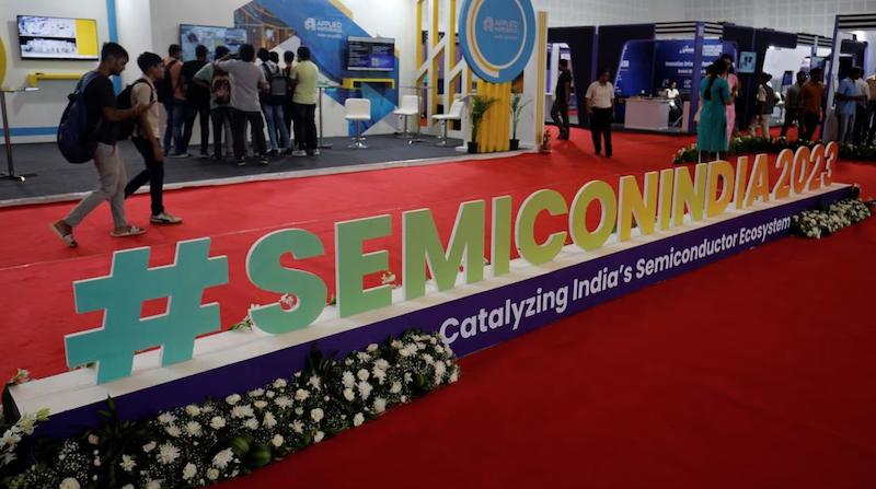 Visitors gather at Applied Materials and Micron Technology kiosks before the start of 'SemiconIndia 2023', India's annual semiconductor conference, in Gandhinagar, India, July 25, 2023. REUTERS/Amit Dave