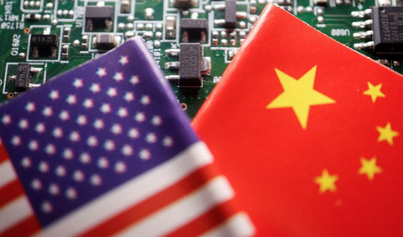 Flags of China and U.S. are displayed on a printed circuit board with semiconductor chips, in this illustration
