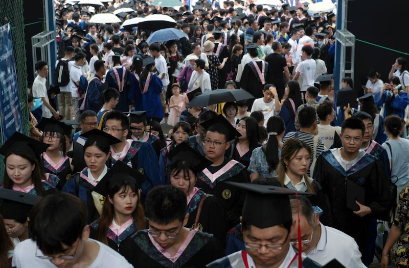 Graduates, including students who could not attend last year due to the coronavirus disease (COVID-19) pandemic, attend a graduation ceremony at Central China Normal University in Wuhan, Hubei province, China June 13, 2021. REUTERS/Stringer CHINA OUT./File Photo