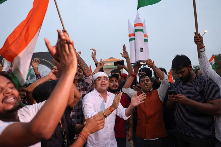 People and supporters of India's ruling Bharatiya Janata Party (BJP) celebrate the Chandrayaan-3 spacecraft's landing on the moon at an event organised near India Gate in New Delhi