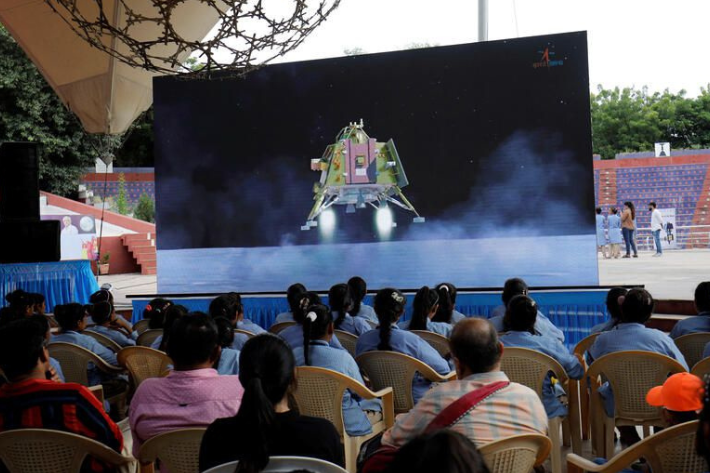 People watch a live stream of Chandrayaan-3 spacecraft's landing on the moon, inside an auditorium of Gujarat Science City in Ahmedabad, India