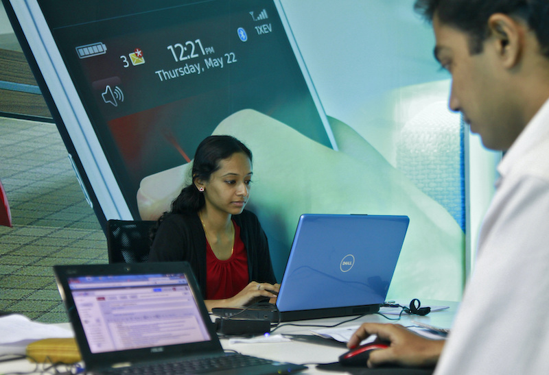 Employees work on their laptops at the Start-up Village in Kinfra High Tech Park in Kochi