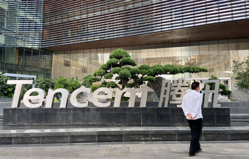 A man walks outside the Tencent headquarters in Nanshan district of Shenzhen, Guangdong province, China September 2, 2022. REUTERS/David Kirton/File Photo Acquire Licensing Rights