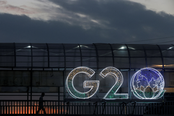 A man walks past an installation on a skywalk ahead of the G20 Summit in New Delhi, India