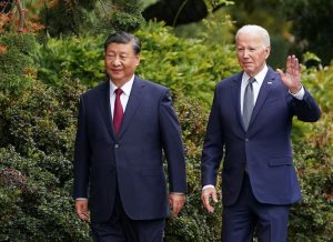 US President Joe Biden waves as he walks with Chinese President Xi Jinping at Filoli estate in Woodside, California