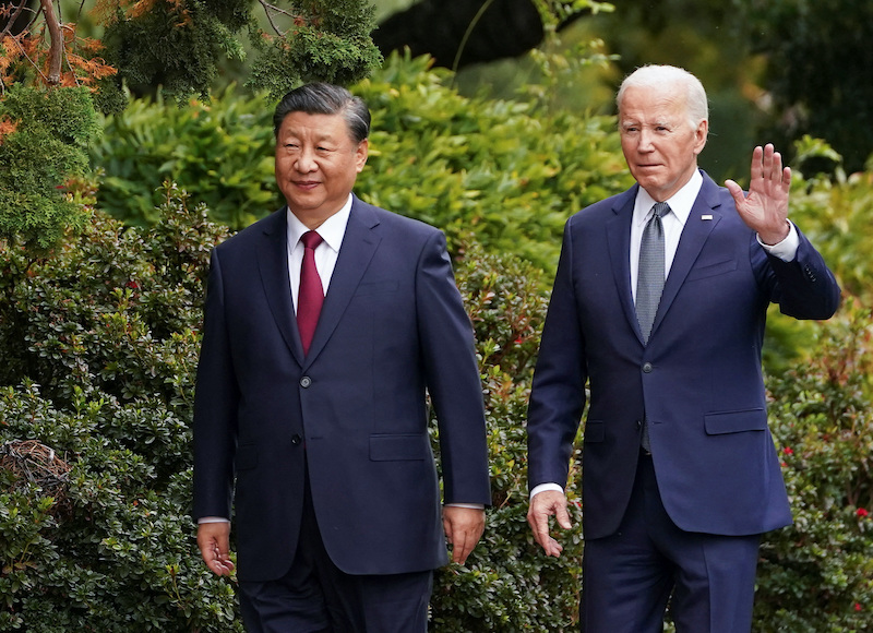 US President Joe Biden waves as he walks with Chinese President Xi Jinping at Filoli estate in Woodside, California