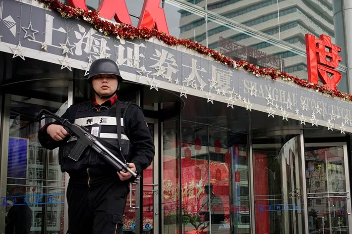 A security guard walks out of the Shanghai Stock Exchange building at the Pudong financial district in Shanghai, China