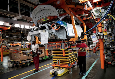 General Motors assembly workers connect a battery pack underneath a partially assembled 2018 Chevrolet Bolt EV vehicle on the assembly line at Orion Assembly in Lake Orion, Michigan, U.S., March 19, 2018. REUTERS/Rebecca Cook/File Photo/File Photo Acquire Licensing Rights