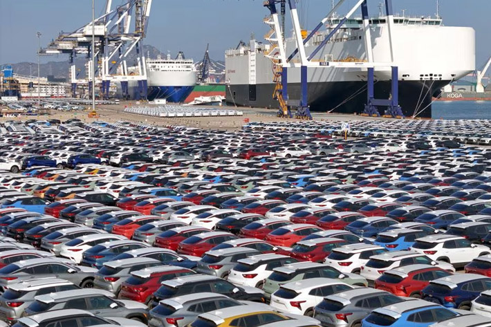 Cars to be exported sit at a terminal in the port of Yantai, Shandong province, China