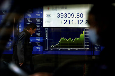An electronic screen displaying Japan's Nikkei share average and stock prices is seen through a car as the share average hits a record high in Tokyo, Japan February 26, 2024. REUTERS/Issei Kato/File Photo Purchase Licensing Rights