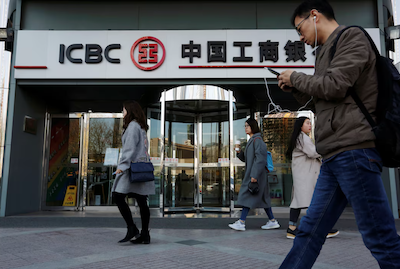 People walk past a branch of Industrial and Commercial Bank of China (ICBC) in Beijing, China April 1, 2019. Picture taken April 1, 2019. REUTERS/Florence Lo/File Photo Purchase Licensing Rights