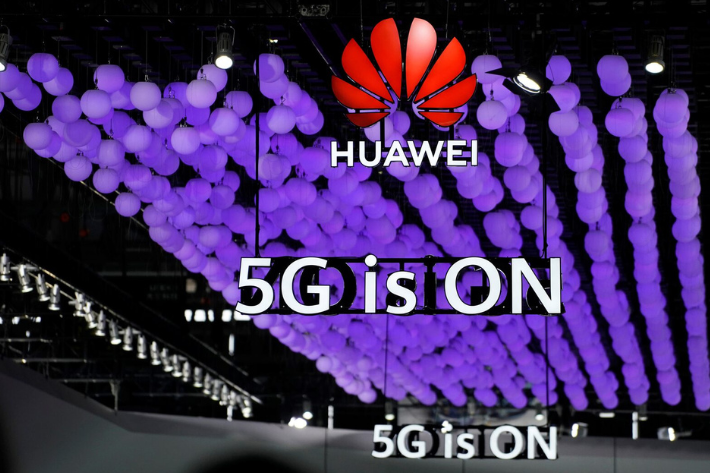 A Huawei logo and a 5G sign are pictured at Mobile World Congress (MWC) in Shanghai, China