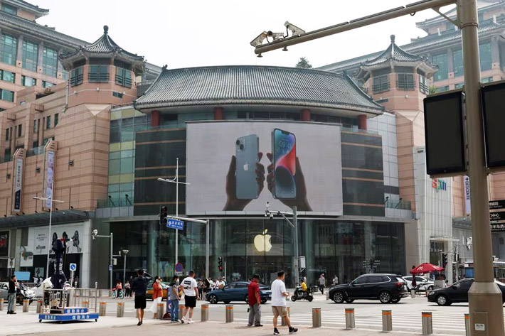 Surveillance cameras are seen near an iPhone advertisement at an Apple store in Beijing, China