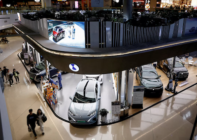 Electric vehicle (EV) models are displayed at the booths of Denza, a joint venture between Mercedes-Benz Group AG and BYD Auto, and Chinese EV maker Voyah, at a shopping mall in Beijing, China, Nov. 3, 2023. REUTERS/Tingshu Wang/File Photo Purchase Licensing Rights