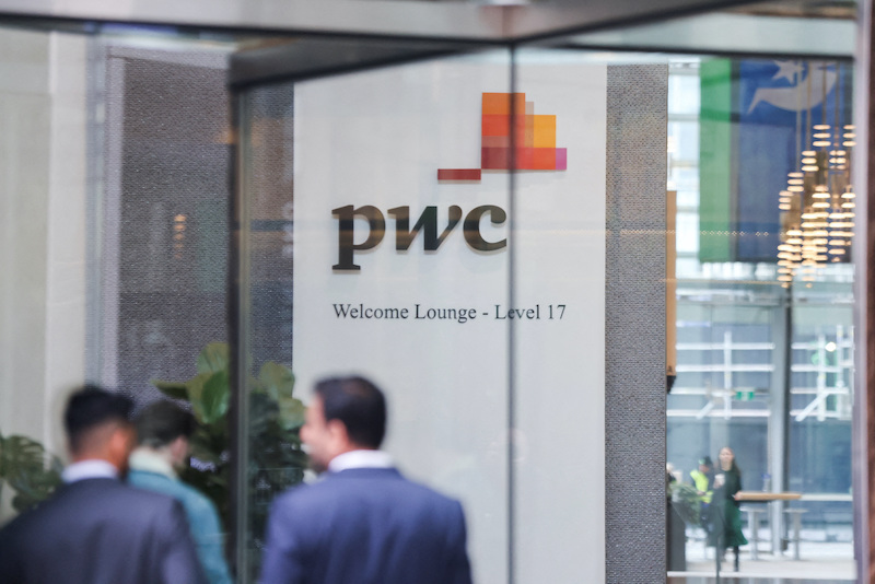 PwC signage is seen in the lobby of their offices in the Barangaroo tower in Sydney, Australia