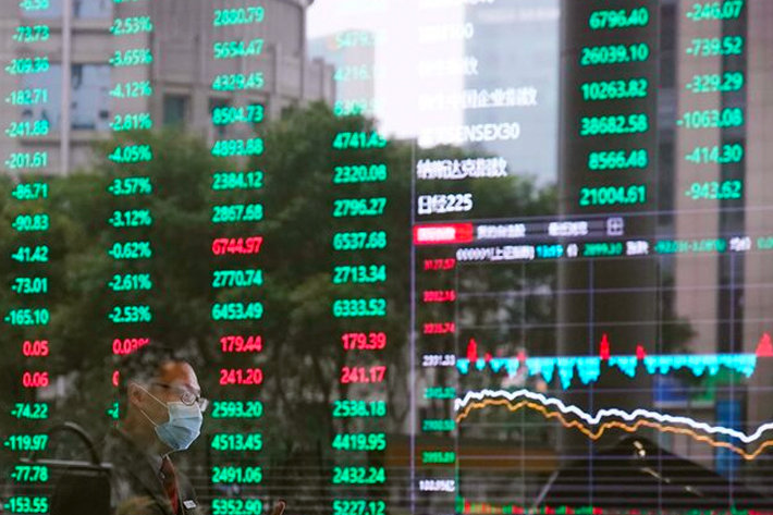 A man wearing a face mask is seen inside the Shanghai Stock Exchange building, as the country is hit by a novel coronavirus outbreak, at the Pudong financial district in Shanghai, China
