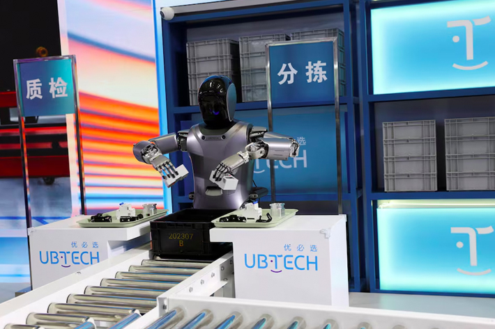 A UBTECH humanoid robot demonstrates its applications on a factory assembly line, at the World Robot Conference.