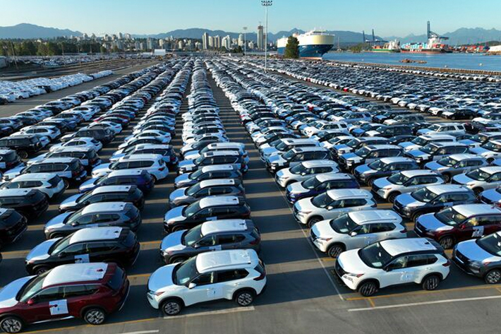 New cars are parked in rows after arriving by ship at Annacis Island in Delta, British Columbia, Canada