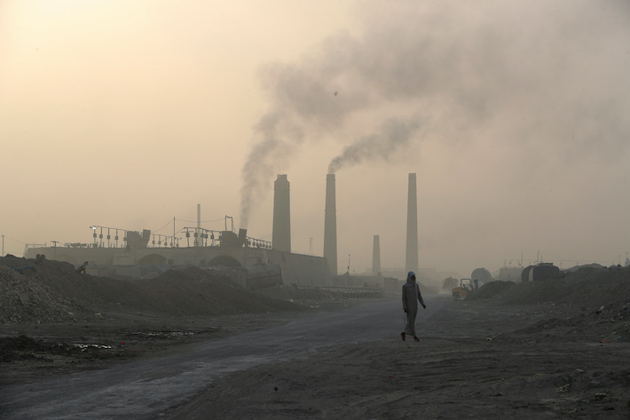 Smoke rises from brick factories in the town of Nahrawan in Baghdad, Iraq