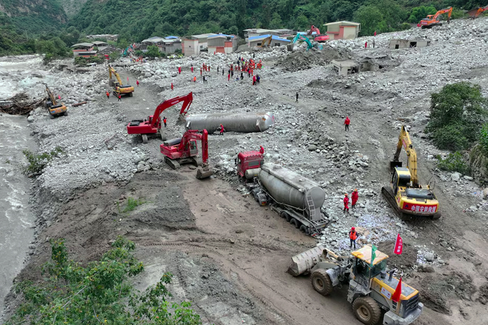 A drone view shows rescue workers carrying out repairing work at a highway damaged by a flash flood and landslide in Ridi village, Ganzi Tibetan Autonomous Prefecture of Kangding, Sichuan province, China.