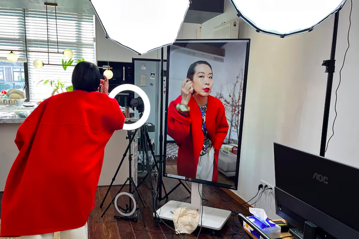 Influencer Tera Feng prepares before hosting a livestream sales session on the social media platform Xiaohongshu, at her apartment in Shanghai, China.