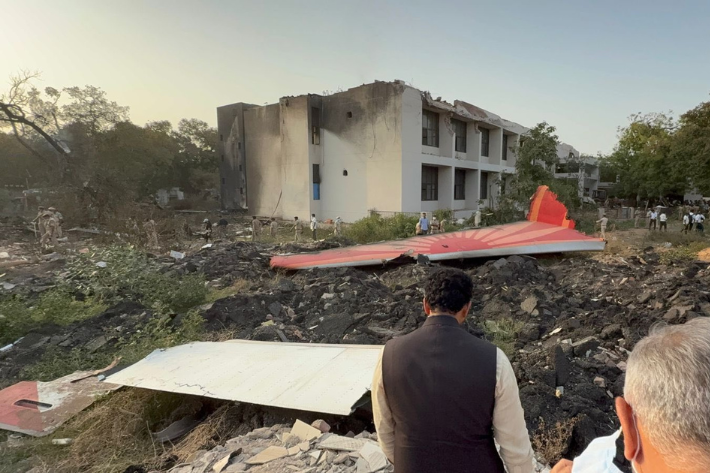 Indian Civil Aviation Minister Ram Mohan Naidu looks on as debris lie at the site where an Air India aircraft, bound for London's Gatwick Airport, crashed during take-off from an airport in Ahmedabad, India
