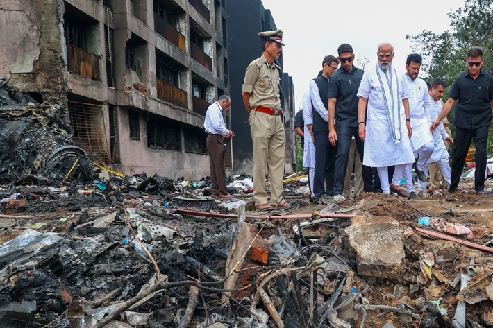 Indian Prime Minister Narendra Modi visits the site where an Air India aircraft, bound for London's Gatwick Airport, crashed during take-off from an airport in Ahmedabad, India