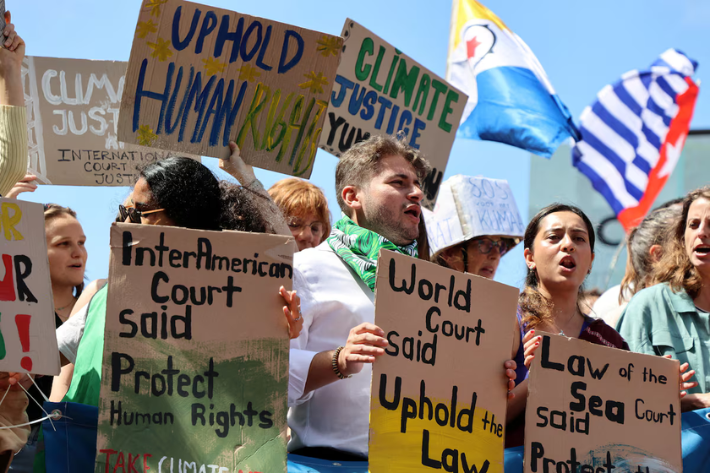 Climate activists and campaigners demonstrate outside the International Court of Justice (ICJ) ahead of the reading of an advisory opinion that is likely to determine the course of future climate action across the world, The Hague, Netherlands, July 23, 2025