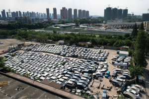 Abandoned new energy vehicles are seen on a vacant lot in Hangzhou, Zhejiang province, China