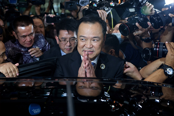 Bhumjaithai Party leader Anutin Charnvirakul reacts next to members of the media after he was elected Thailand's new prime minister at the parliament